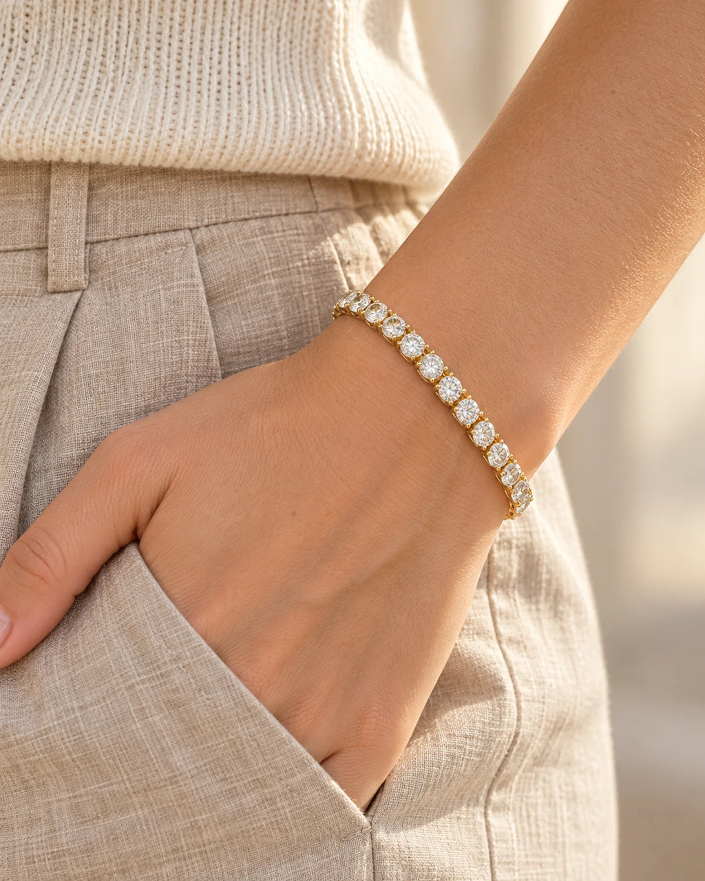 Gold moissanite tennis bracelet worn with linen trousers