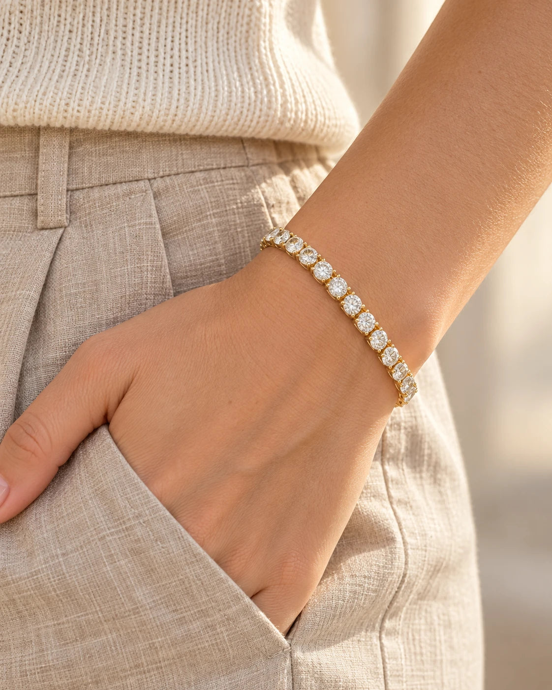 Gold moissanite tennis bracelet worn with linen trousers