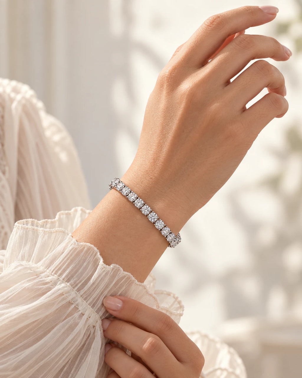 Silver moissanite tennis bracelet worn with a sheer ivory blouse